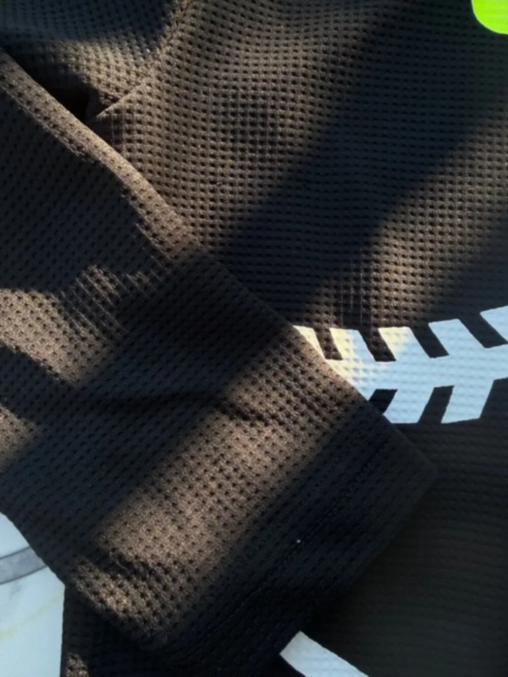 Nike Dri-FIT hoodie featuring a neon yellow swoosh logo and baseball stitching